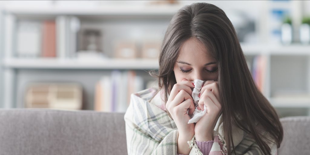 woman blowing nose