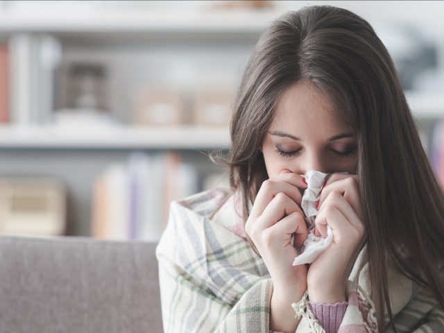 woman blowing nose